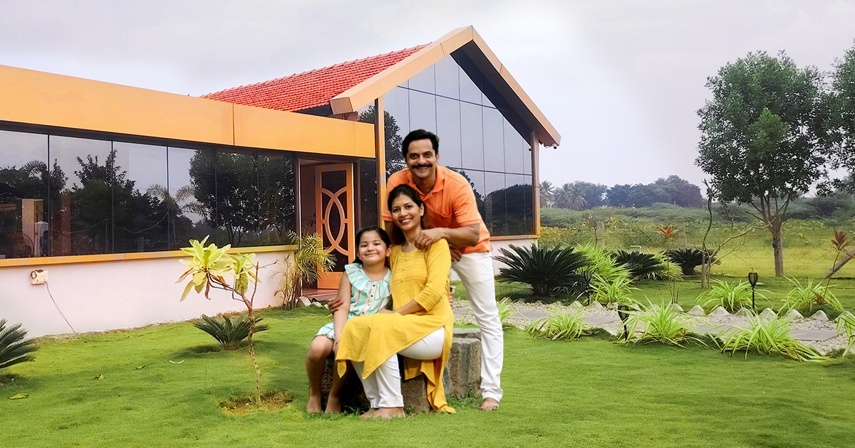 Happy family smiling outside Nandi Farm Resort